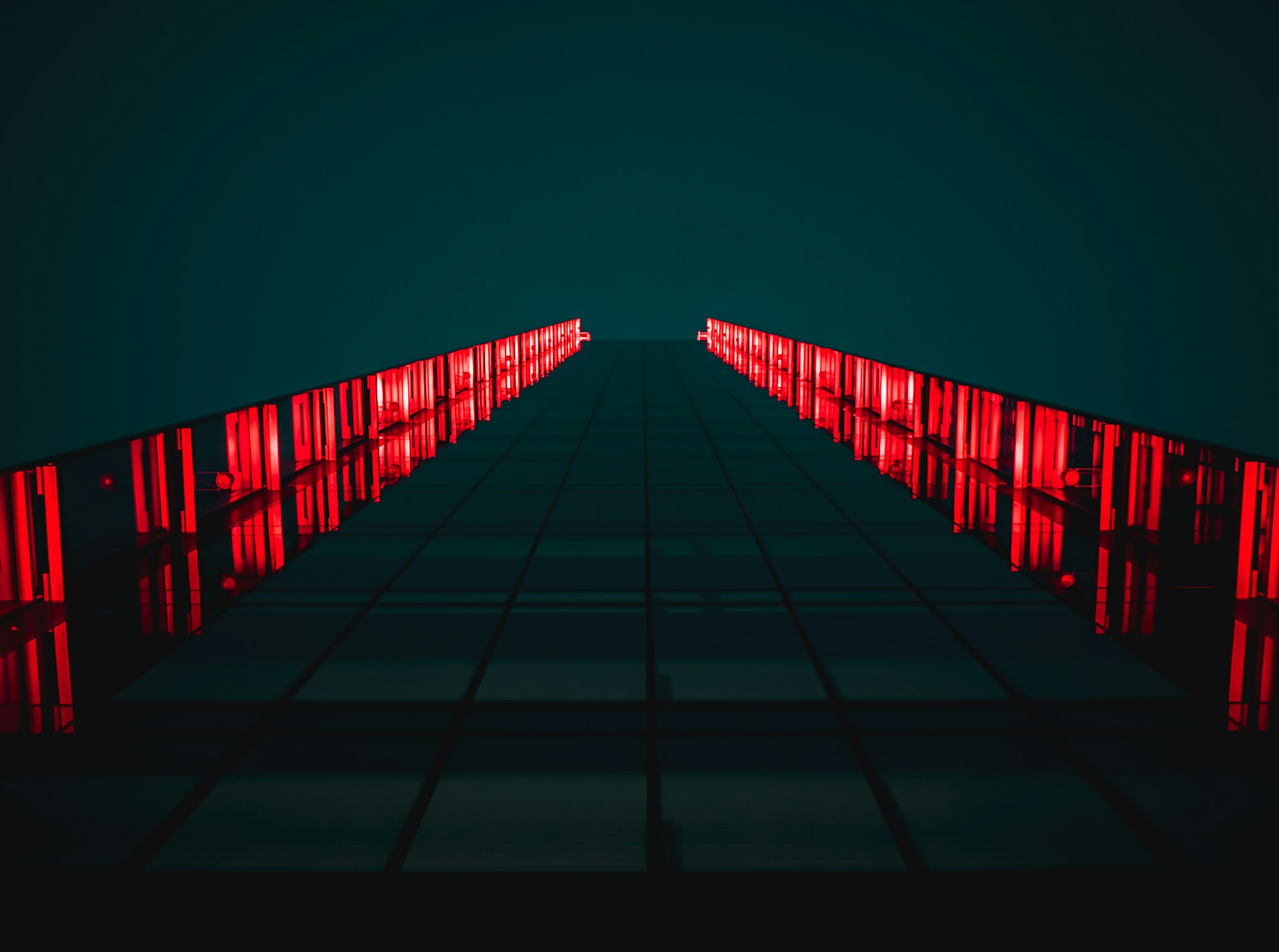 black pathway between red LED light rails